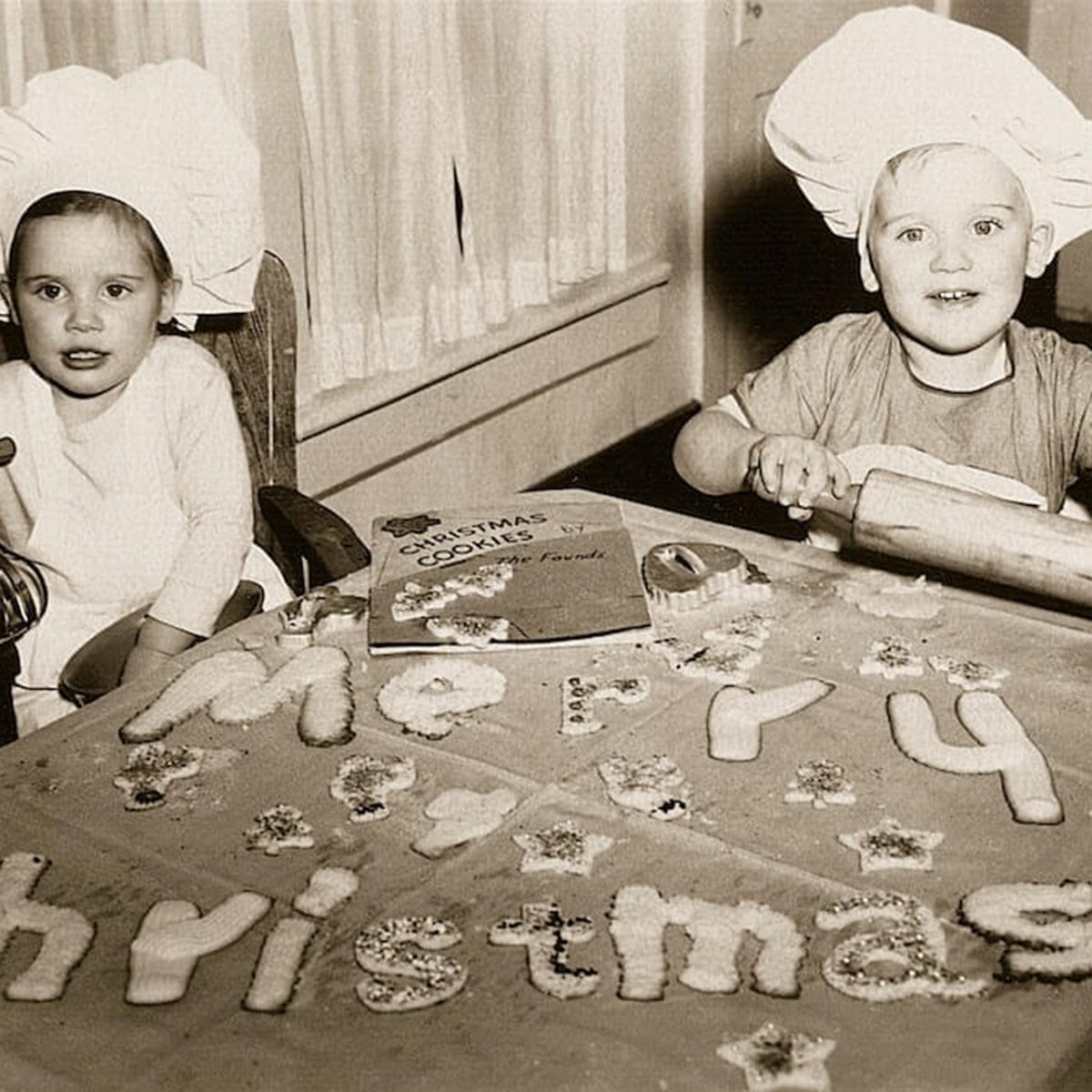 Black and white photo of two kids spelling out 