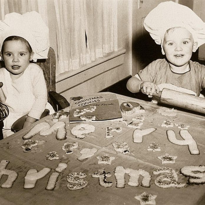 Black and white photo of two kids spelling out