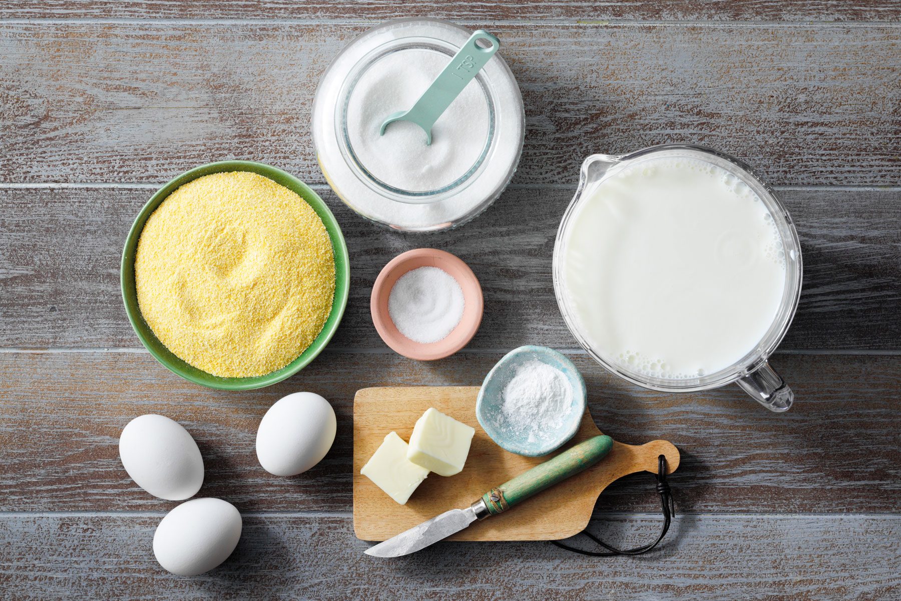 Cornmeal, eggs, milk placed on a table