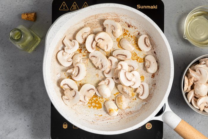 Sautéing Mushrooms In A White Non Stick Skillet on Induction Cooktop