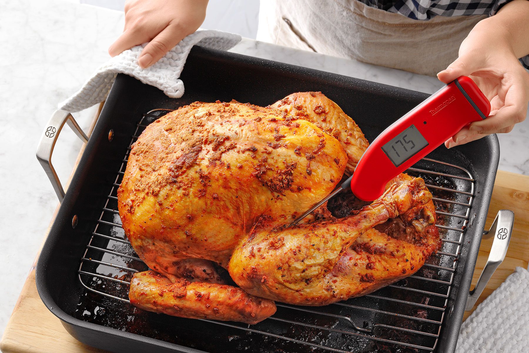 Checking the temperature of the cooked turkey