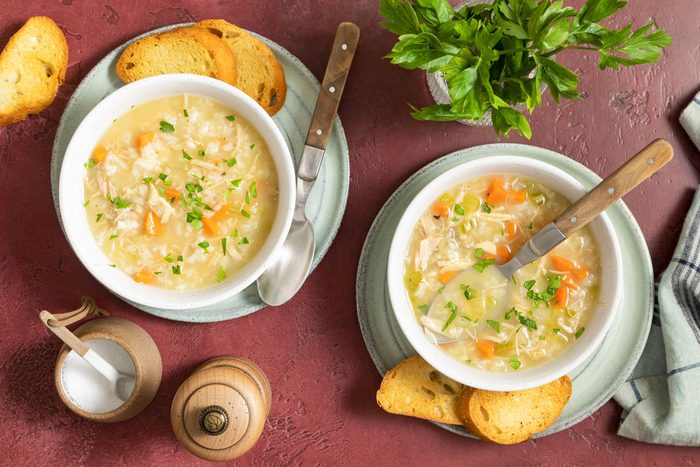 Turkey Soup Served in Ceramic Bowls with Spoons