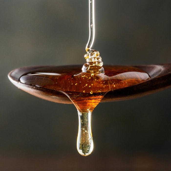 Honey poured onto spoon
