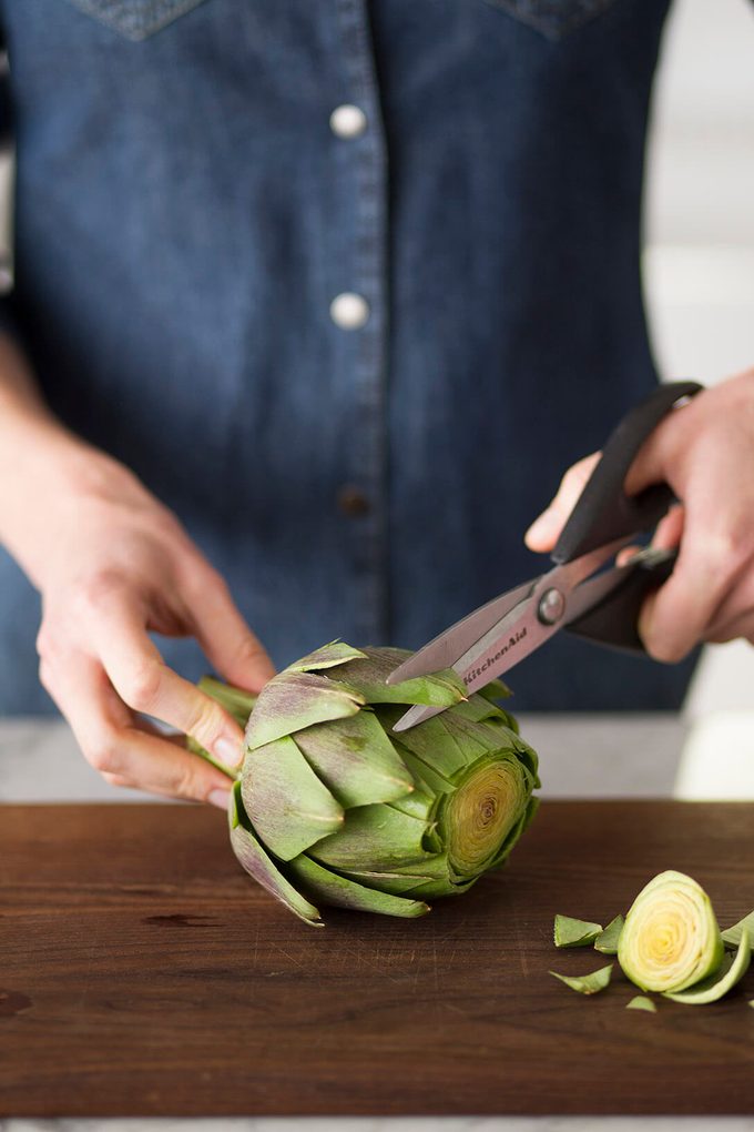 Snipping artichoke leaves