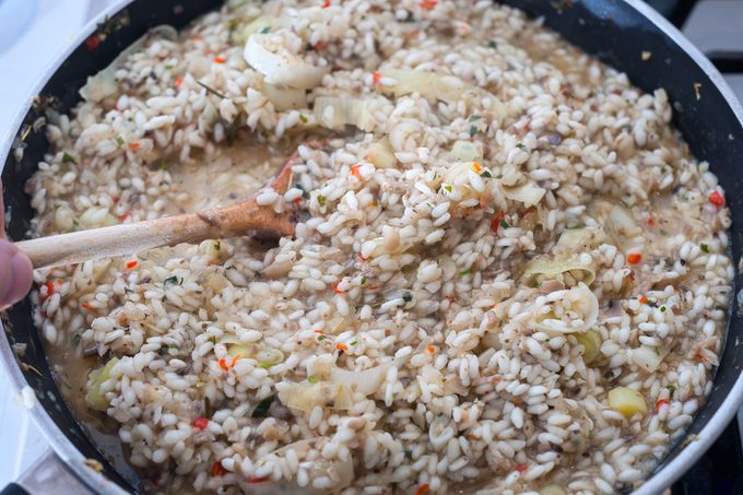 Preparing risotto on the stovetop using arborio rice.