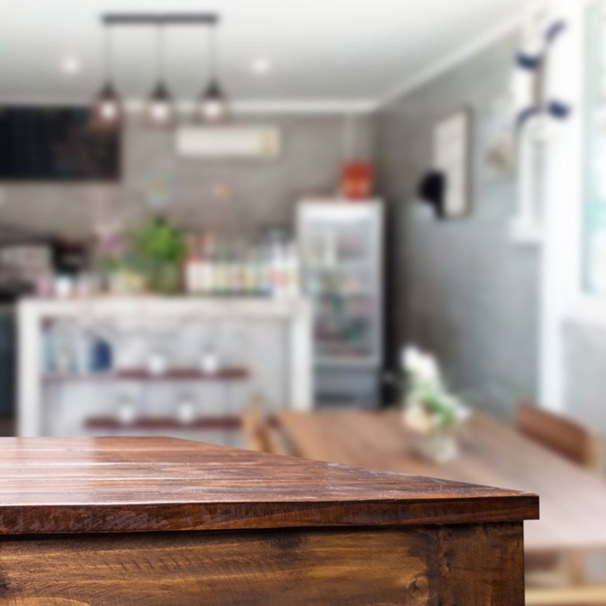 Selected focus empty brown wooden table and Coffee shop or restaurant blur background with bokeh image.