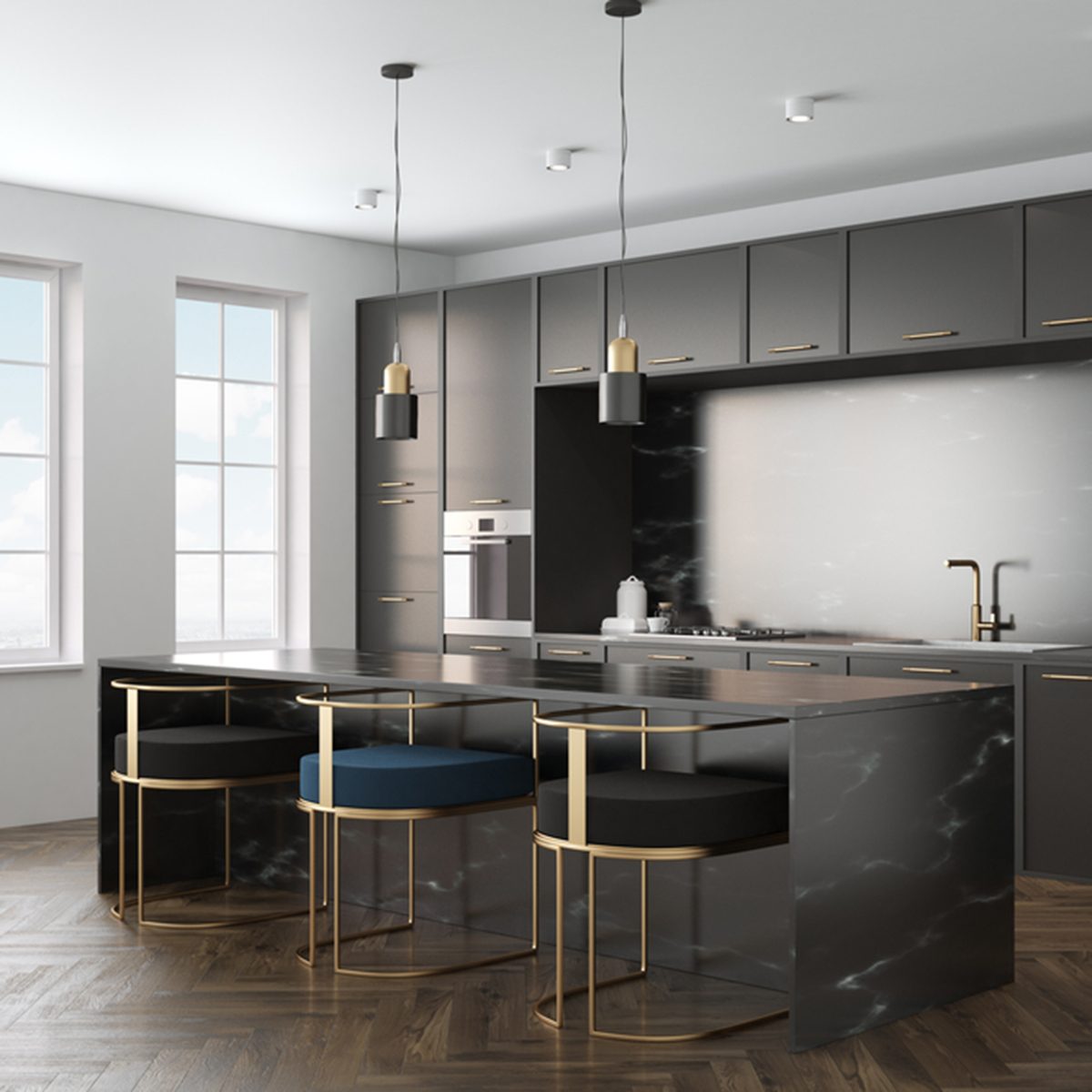 Kitchen interior with a wooden floor, black marble countertops and black cupboards with built in appliances.