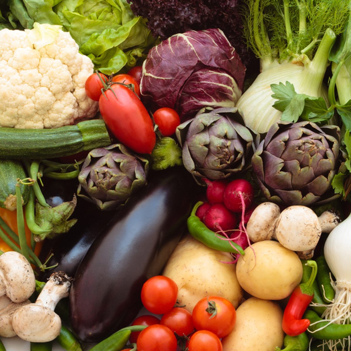 Background of mixed fresh organic vegetables and herbs.