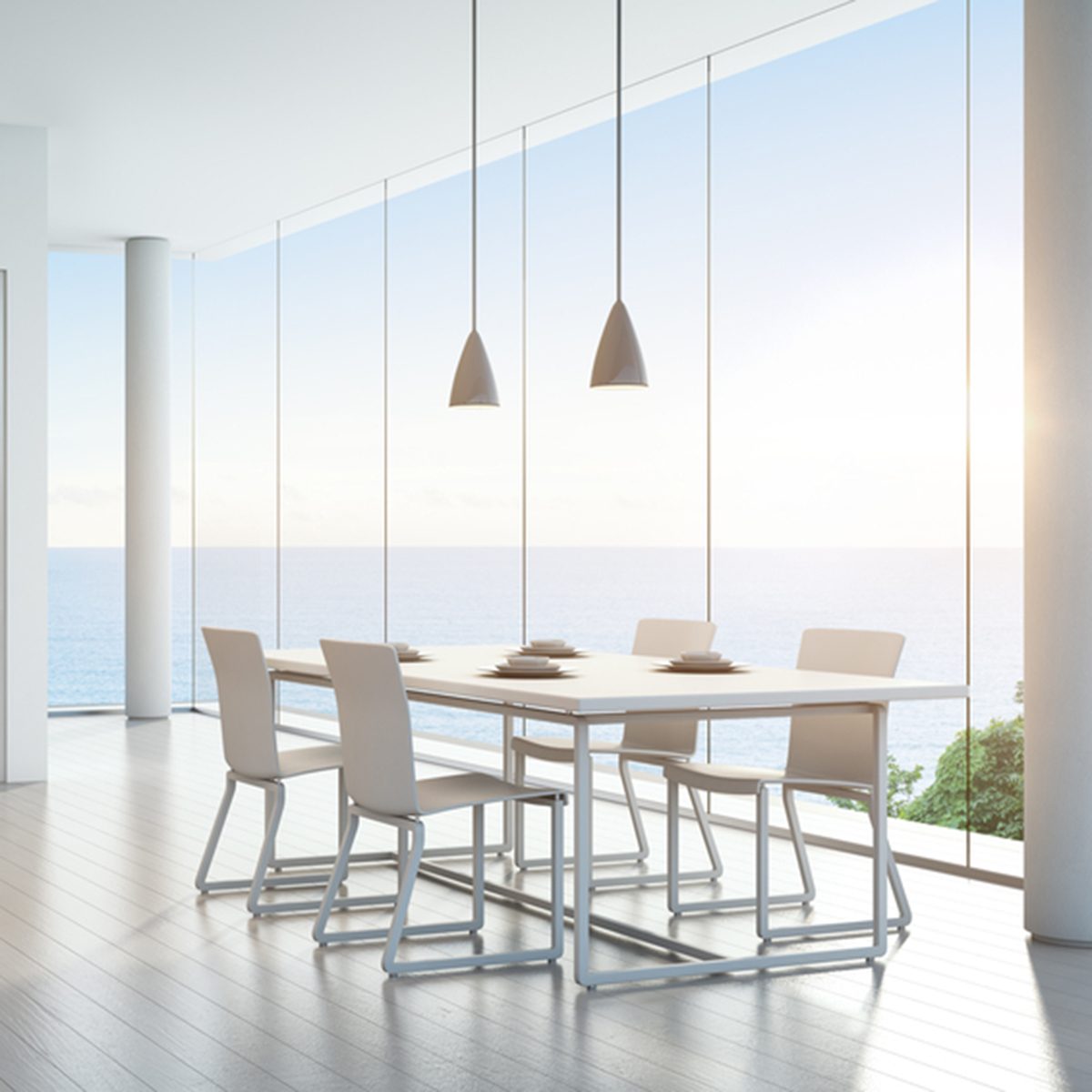 Sea view kitchen and dining room in luxury vacation home with modern white interior design