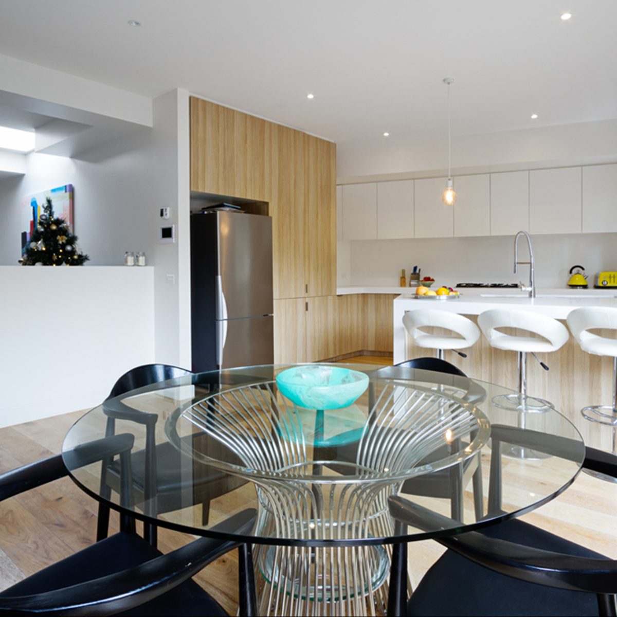 Kitchen with island bench and open plan dining area in modern australian home