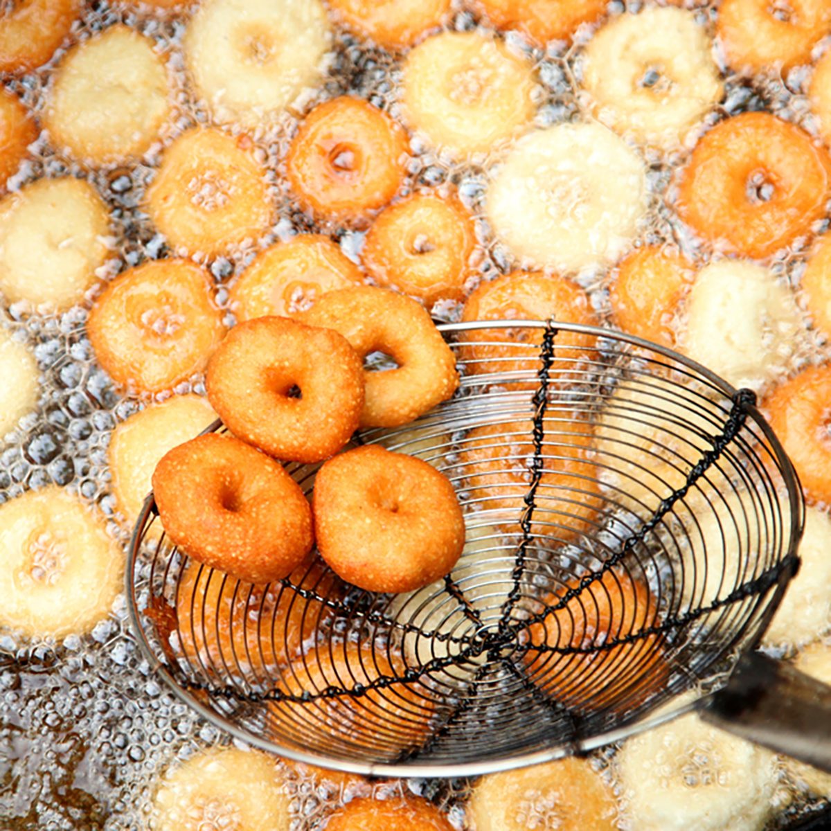 Deep frying medu vada in the pan. Medu Vada is a savoury snack from South India, very common street food in the India