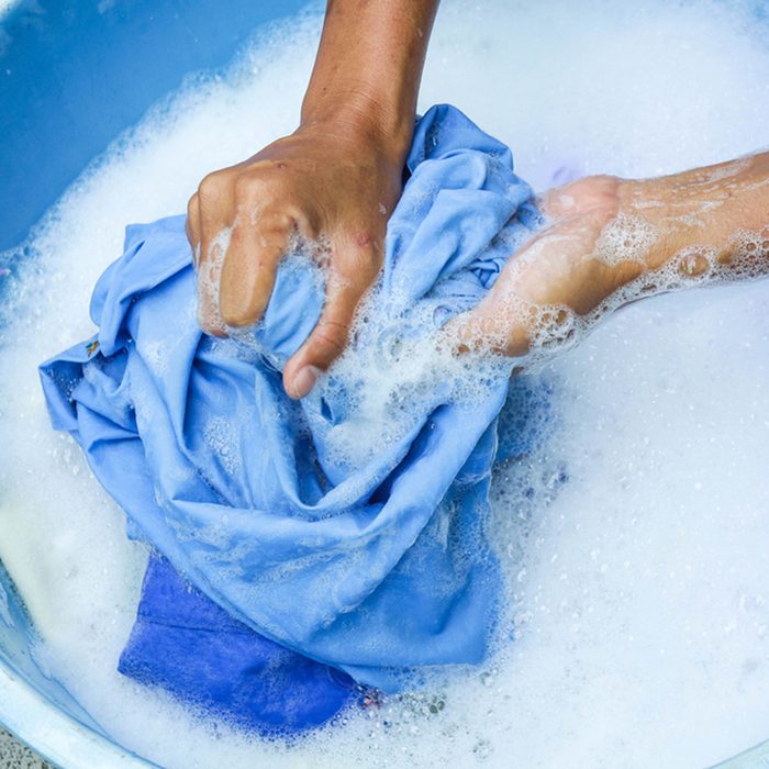 Wash clothing by hand with detergent. Water will wash over wash machine. Hand washing.Space for text; Shutterstock ID 489494236; Job (TFH, TOH, RD, BNB, CWM, CM): TOH