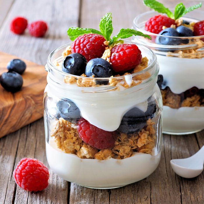 Blueberry and raspberry parfaits in mason jars,