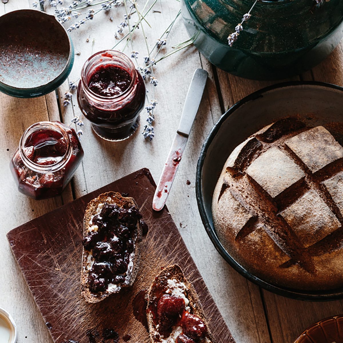 Rye and spelt sourdough toast with butter, blackberry jam, and strawberry preserves.