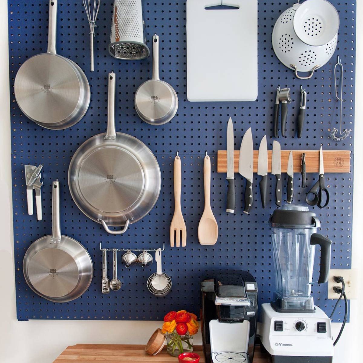 Kitchen with a blue pegboard backsplash