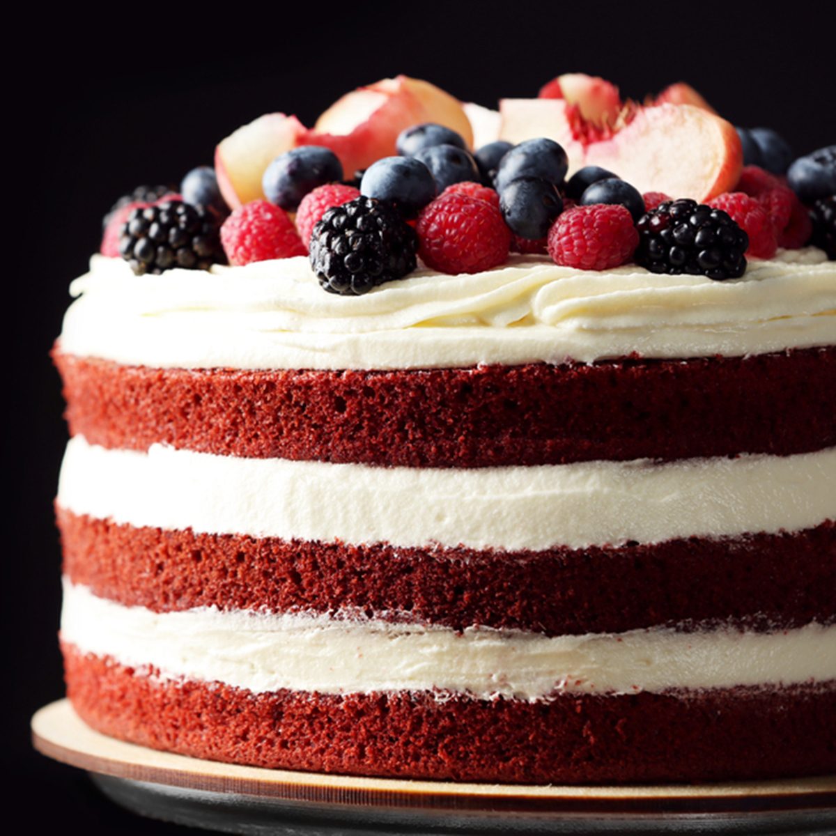 Delicious cake with fruit and berries decoration on wooden table