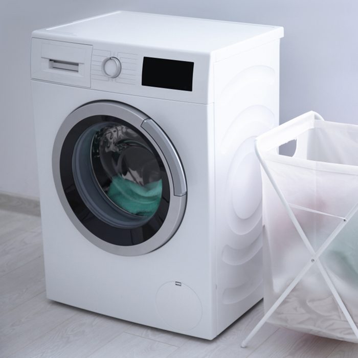 Laundry basket and washing machine indoors