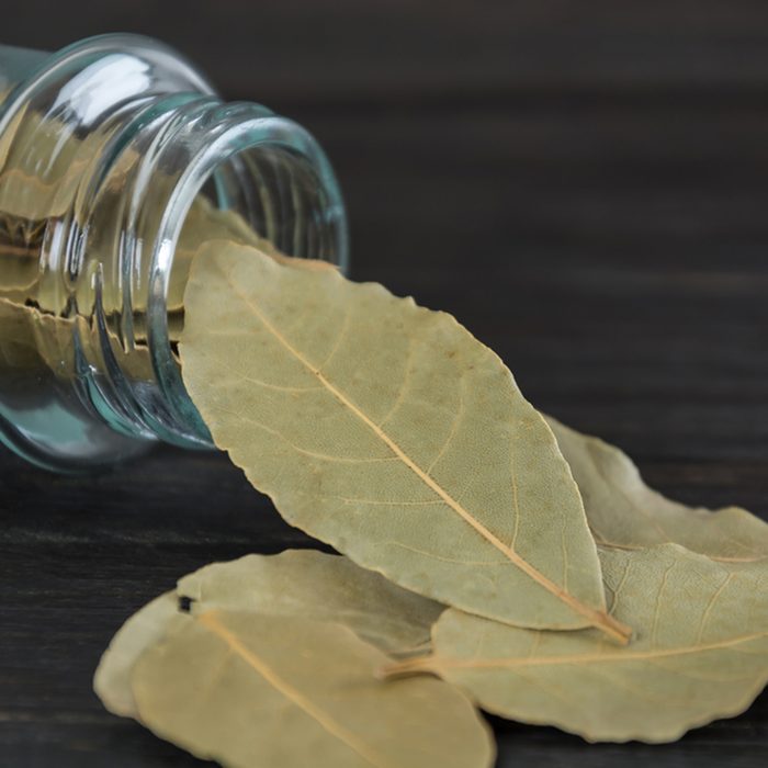 bay leaves in bottle on wood