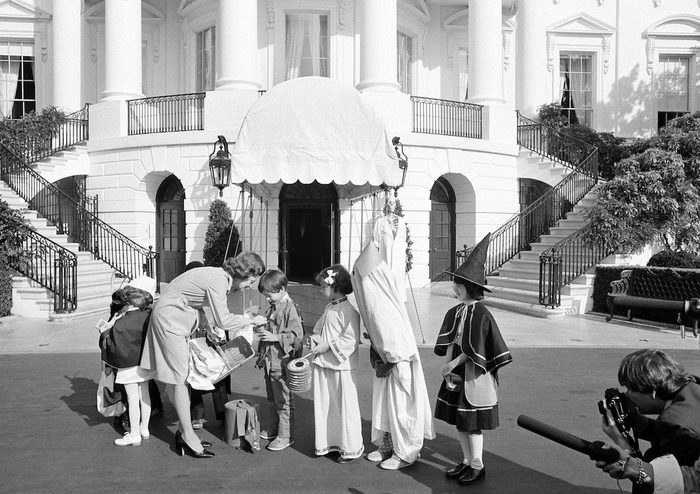 First lady Betty Ford greets costumed school children from the Washington area during a Halloween benefit for the United Nations International Children