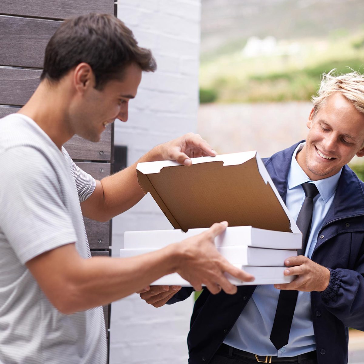 Man getting three pizzas