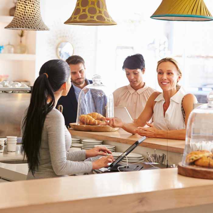 Woman ordering at the counter in a cafe