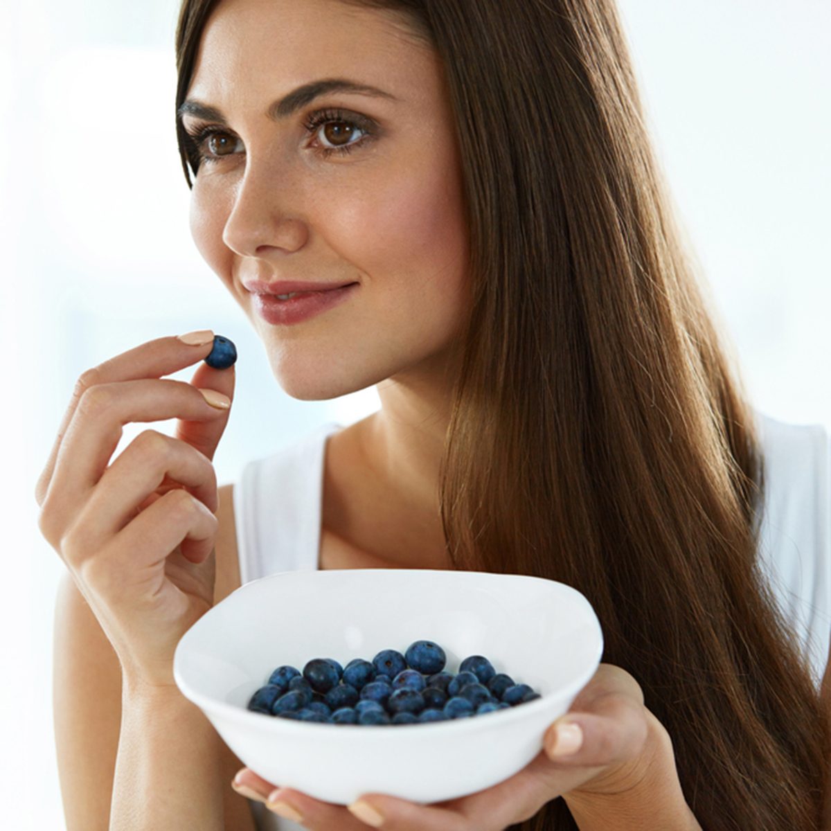 Portrait Of Attractive Smiling Girl Eating Ripe Fresh Juicy Tasty Sweet Organic Blueberries