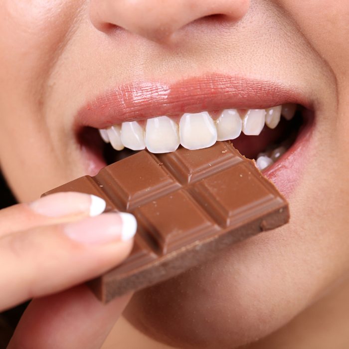 Closeup of woman eating chocolate