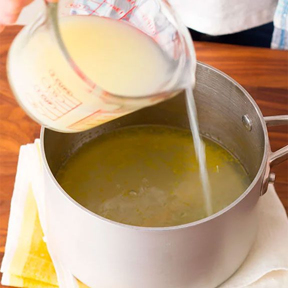 adding fresh lemon juice to lemonade