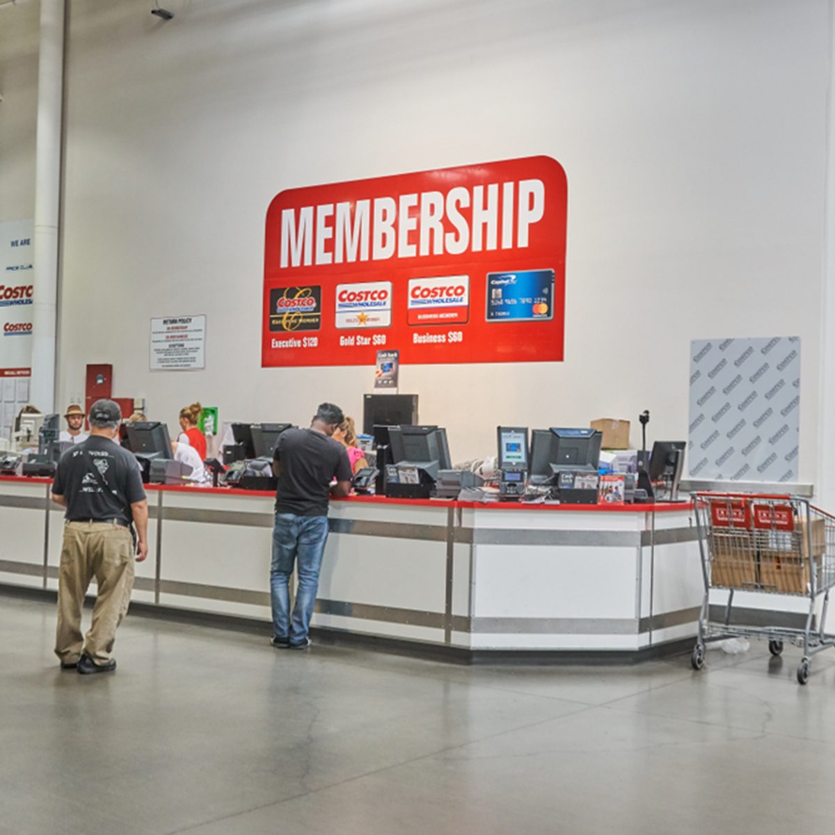 TORONTO, CANADA - AUGUST 15, 2018: Line of a people at customer service desk in a Costco store. Costco, is an American corporation which operates a chain of membership-only warehouse clubs.; Shutterstock ID 1182944260