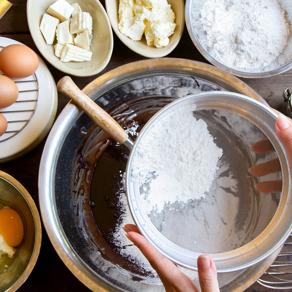 Hand Sift flour, Bakery prepare for make Chocolate brownie cake