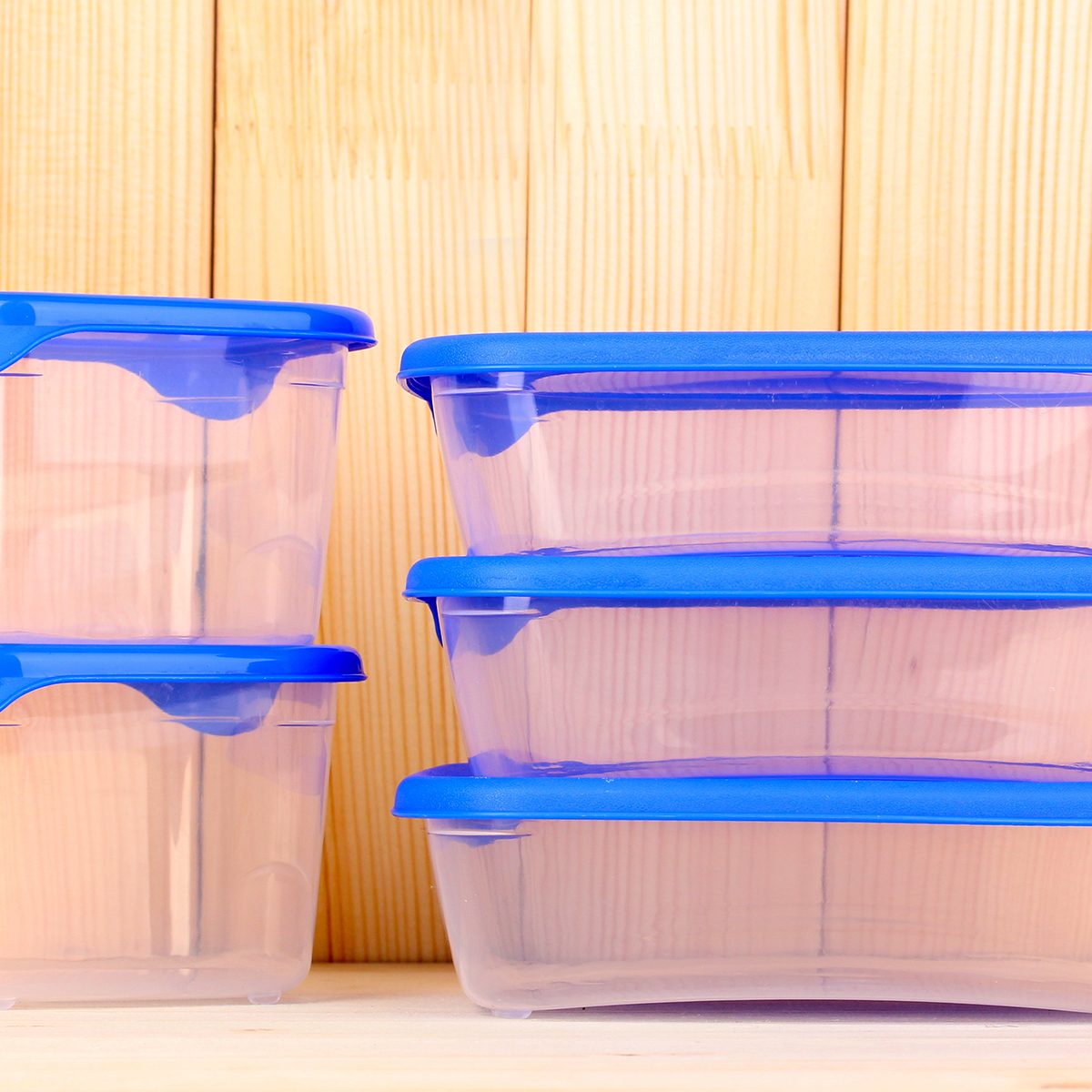 Plastic containers for food on wooden background