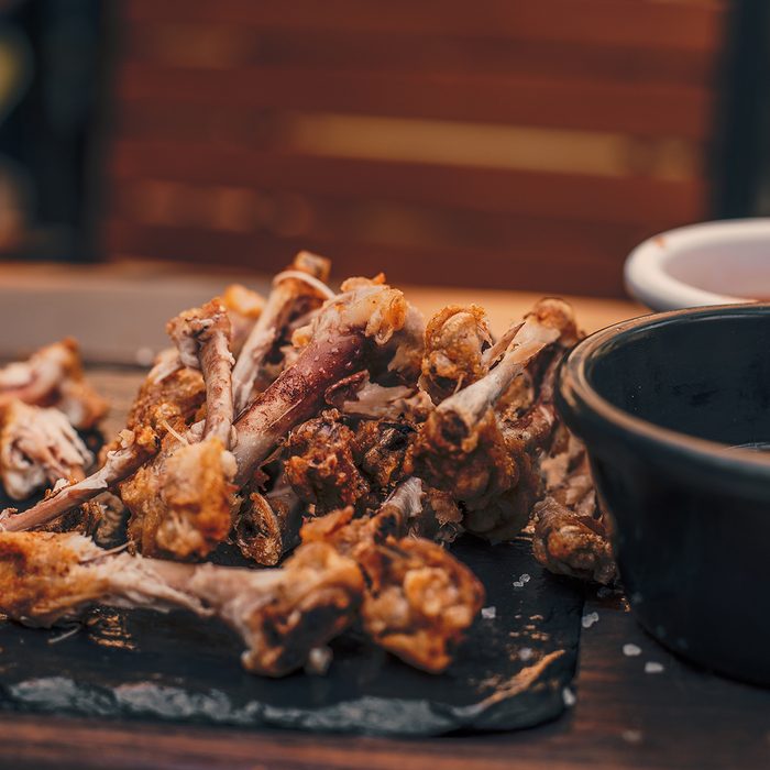 Chicken wings leftovers on table.