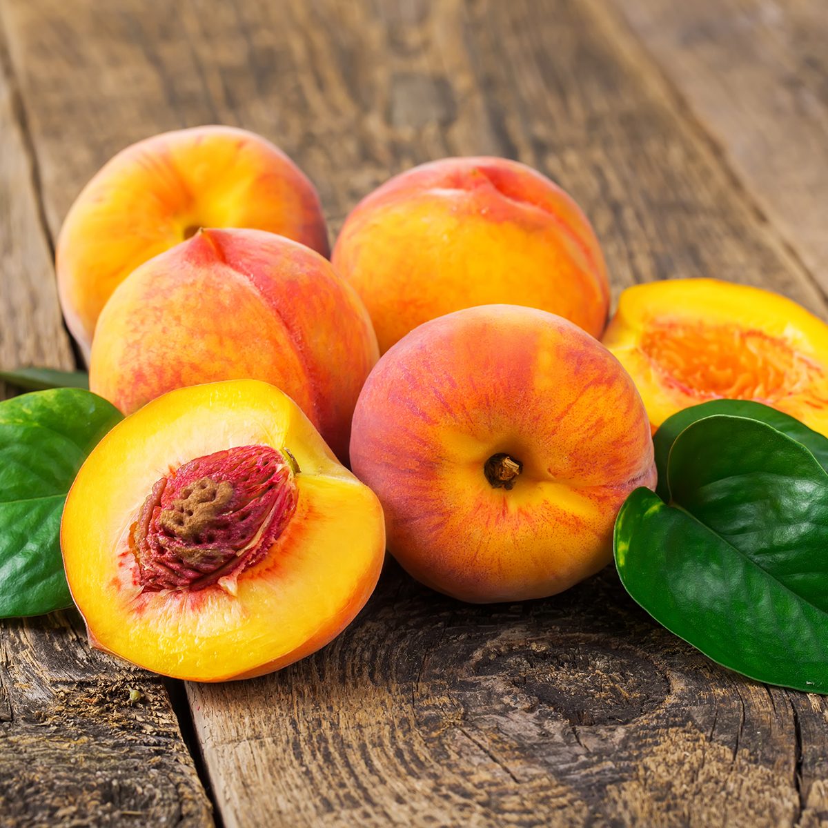 fresh peaches on wood background