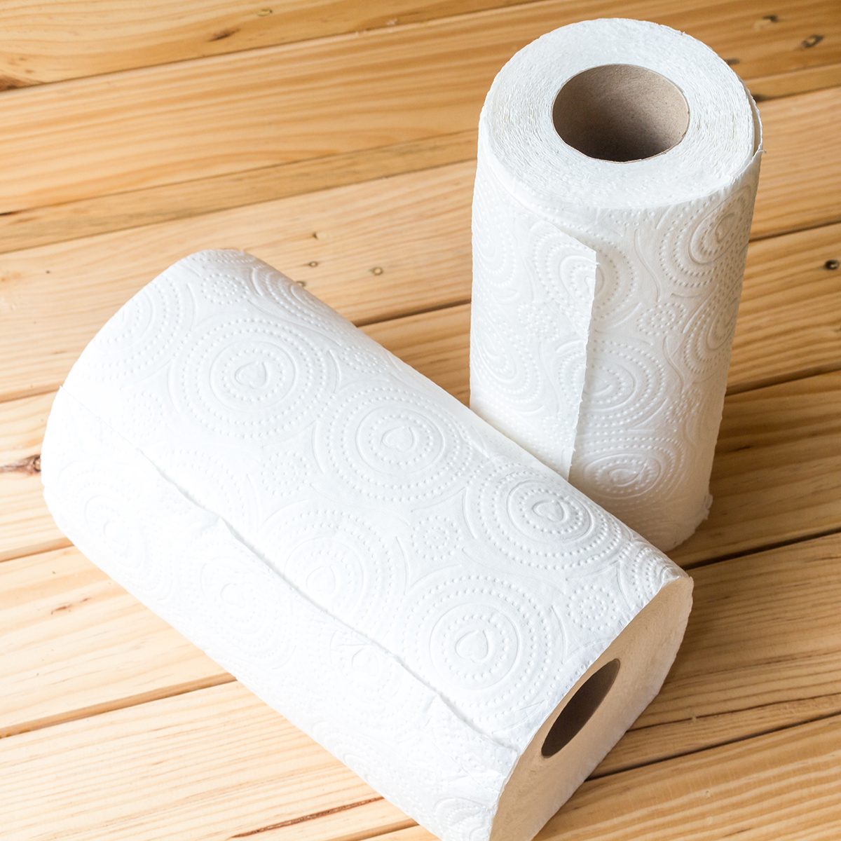 Roll of paper towel on wooden background