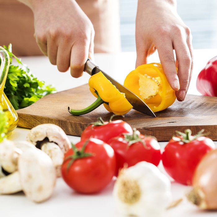 Woman hands cutting vegetables in the kitchen
