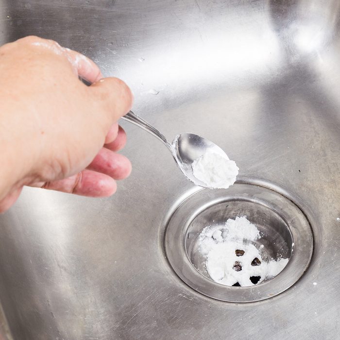 Baking soda poured to unclog drainage system at home; Shutterstock ID 309060395