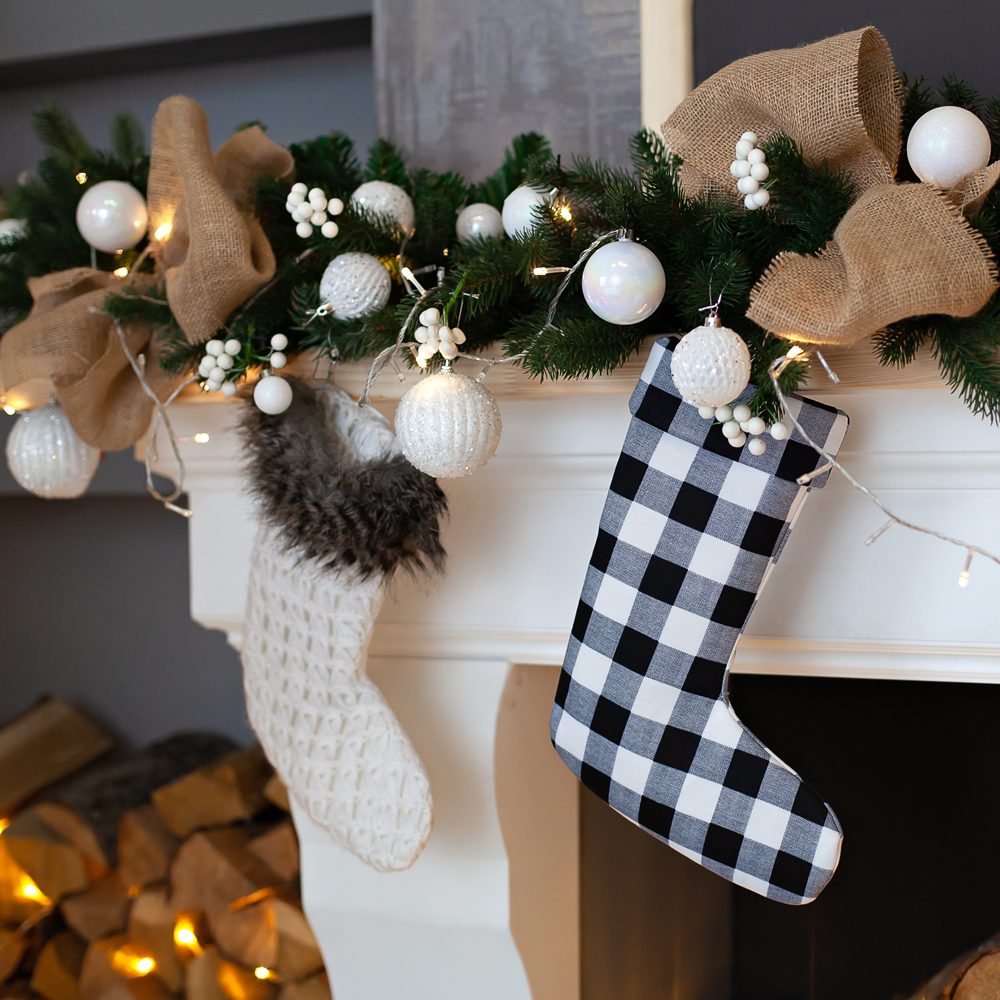 Beautifully Decorated Living Room Mantle, with Christmas Sock Stockings Hanging On Fireplace Waiting For Presents
