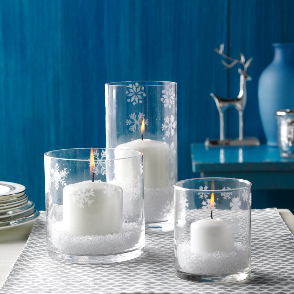 White Christmas Style with Bright White Candles in a Snowflake Etched Candle Holders Against a Blue Christmas Residential Setting