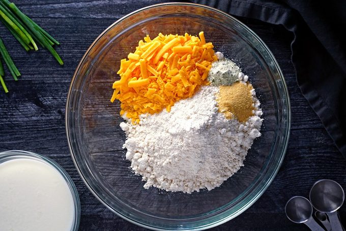 adding biscuit ingredients to a bowl red lobster cheddar bay biscuits