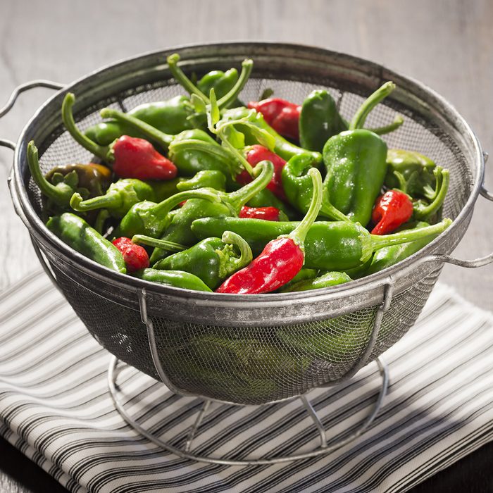Green and Red New Mexican Chile Peppers in a Colander