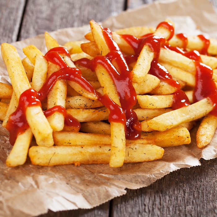 French fries with ketchup served on parchment paper