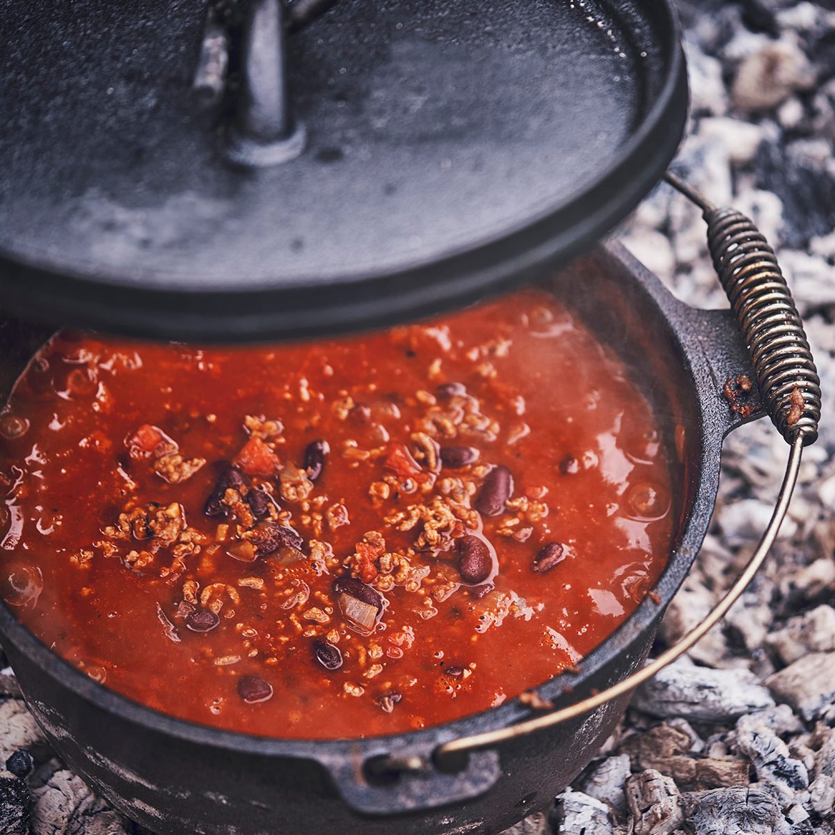 Cooking Chili Con Carne in Dutch Oven over Logfire Outside