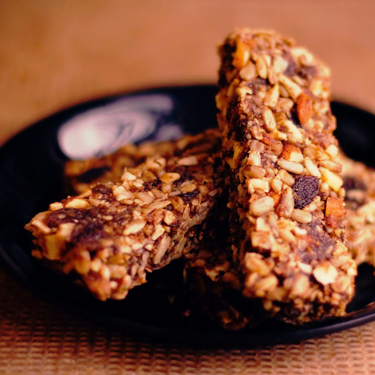 Several organic muesli bars centered on a plate.