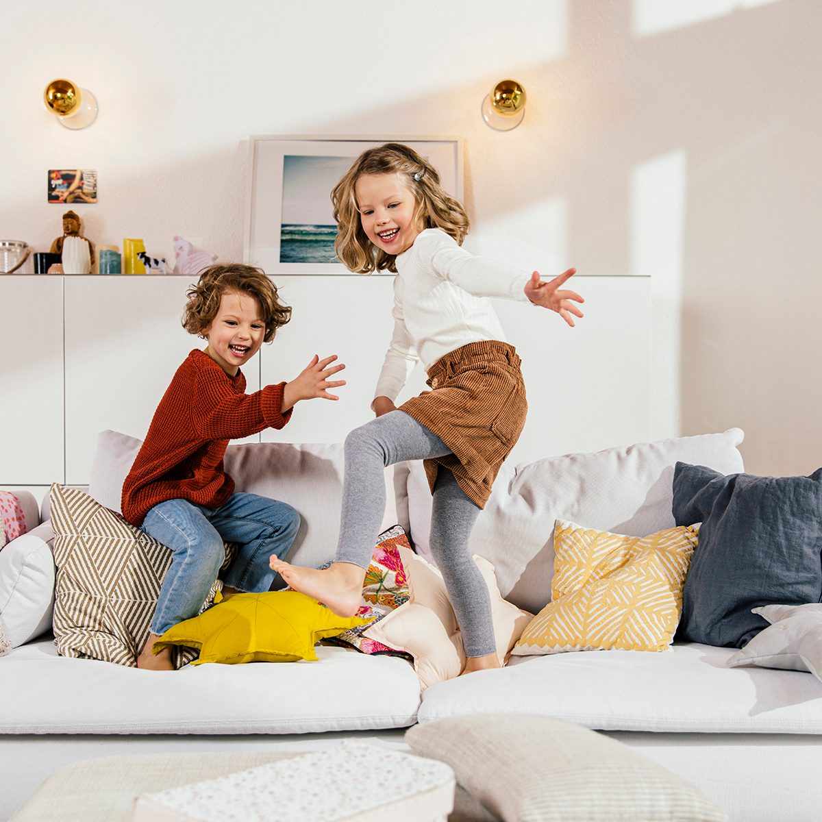 birthday party games for kids Two Happy Girls Jumping On Couch At Home