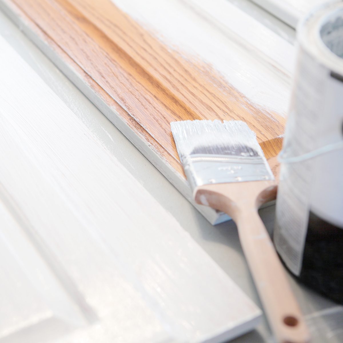 Close up of painting kitchen cabinets white.
