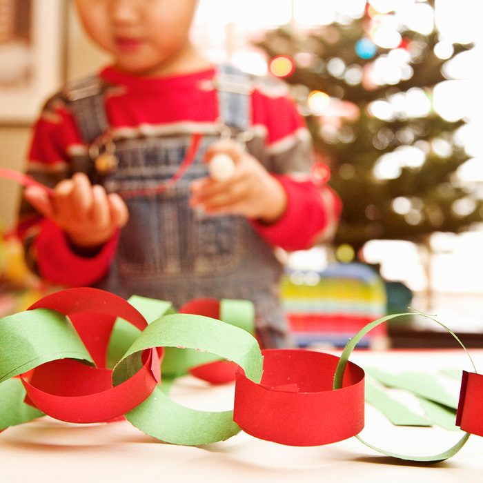 Asian boy making paper chain