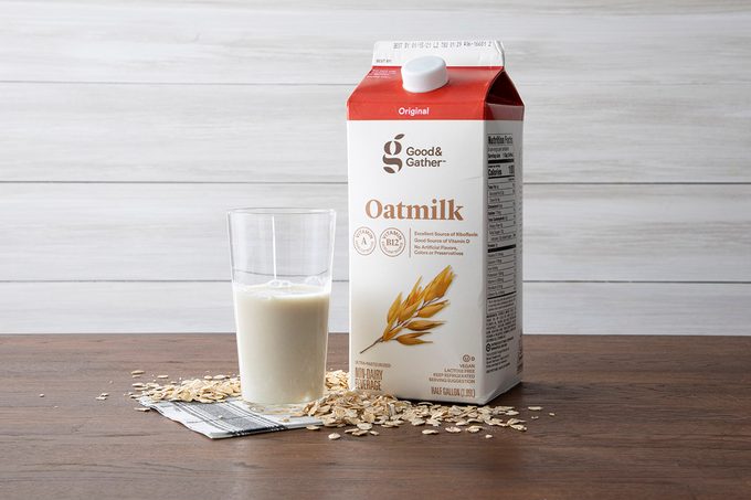 Good & Gather Oat Milk On Counter With Glass And Oats.