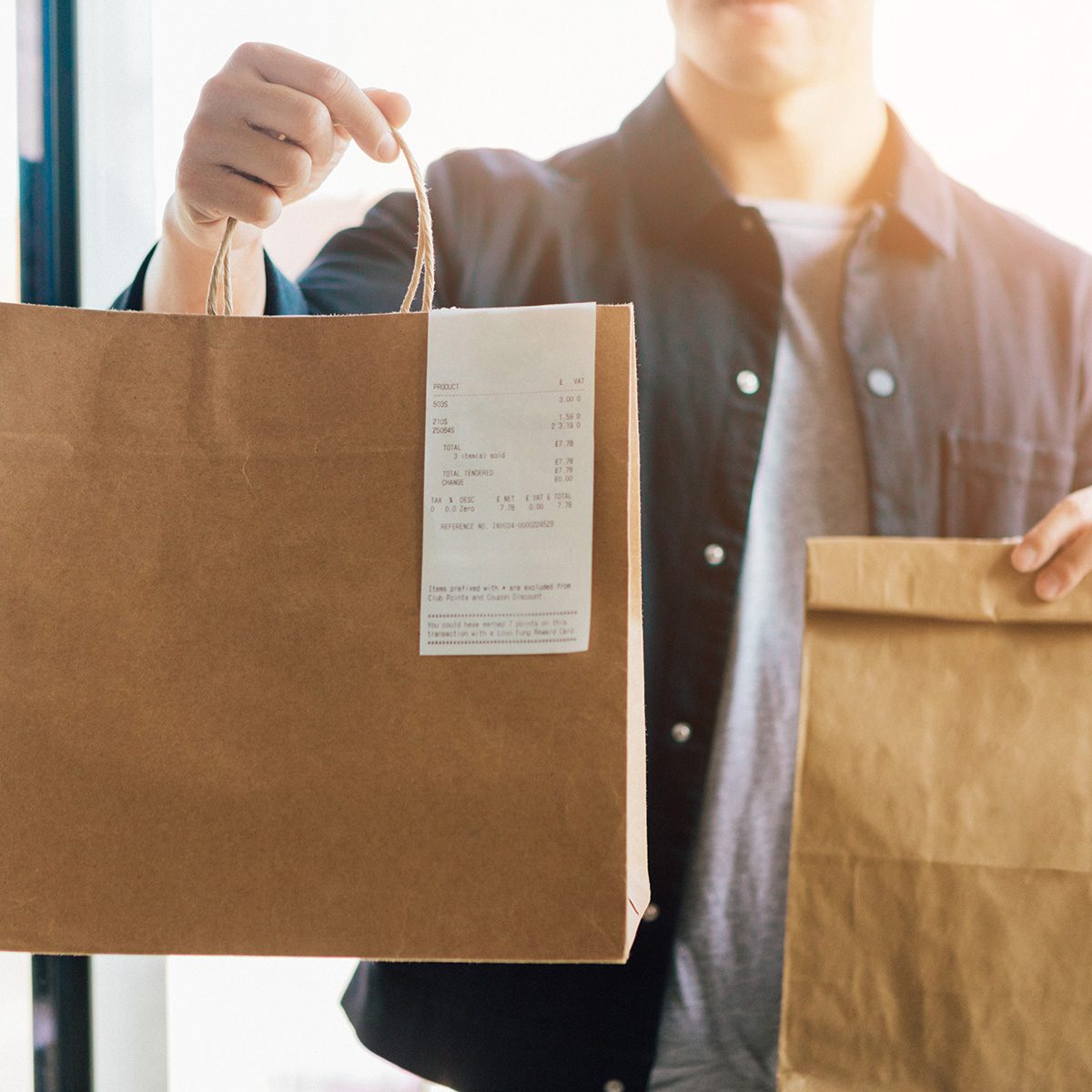 Man Delivering Takeaway Food At The Front Door