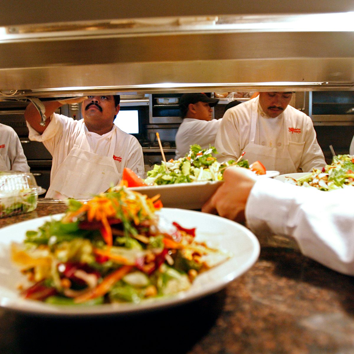 cheesecake factory secrets Cooks hustle to feed the lunchtime crowd at the Cheesecake Factory in Sherman Oaks on Friday, July 28, 2006. High gas prices have caused people to spend less at restaurants but the Cheesecake Factory has felt the trend for the last two quarter and is now launching a new menu and selective advertising to attract customers. (Photo by Myung J. Chun/Los Angeles Times via Getty Images)