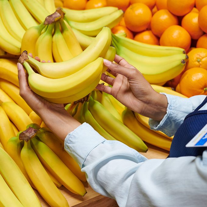 Walmart employee inspecting banana